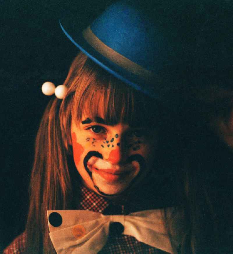 Girl with hat painted as a clown for carnival in Portrait in Berlin