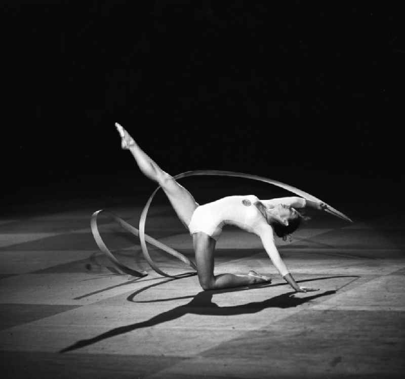 Recording of sports show of DTSB (German Sports and Gymnastics Union) - a gymnast presents in Rhythmic Gymnastics their exercise with the band- in Berlin in Germany