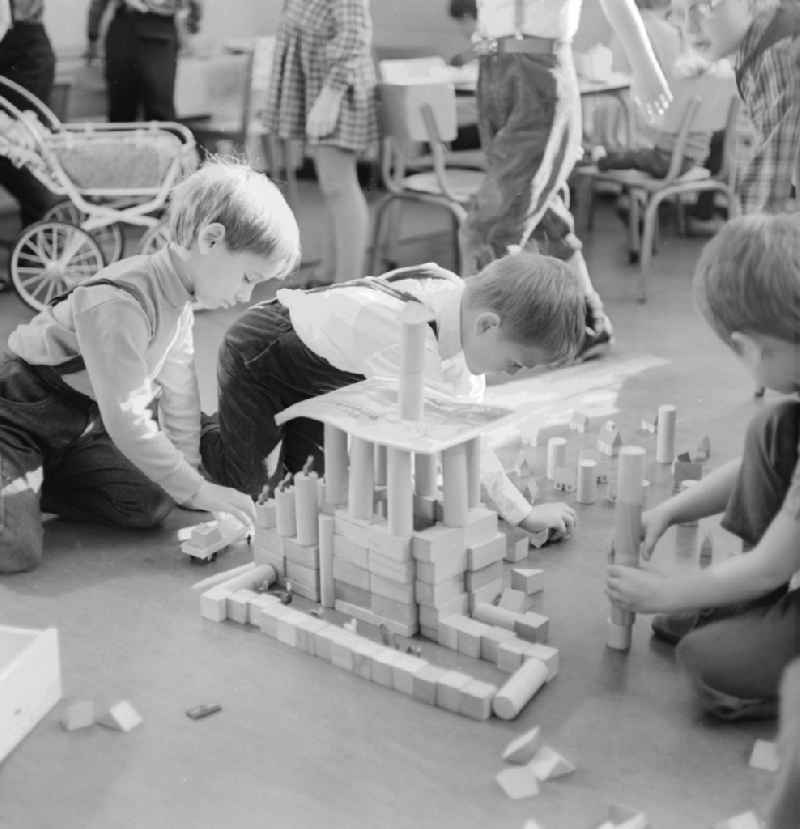 Kids playing with wooden building blocks in Berlin