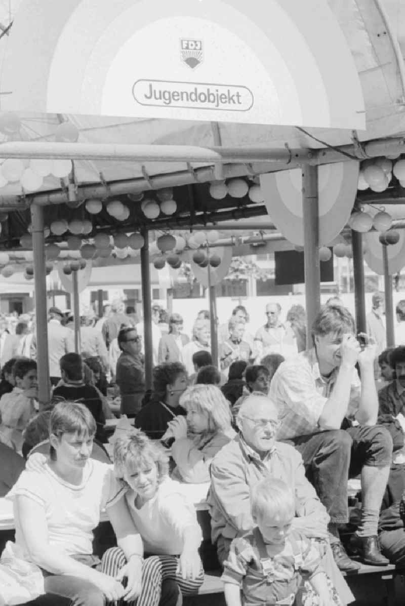 Rush of visitors in restaurants and party tents at the fair for public entertainment during the 1st of may at the Alexanderplatz in Berlin in Germany