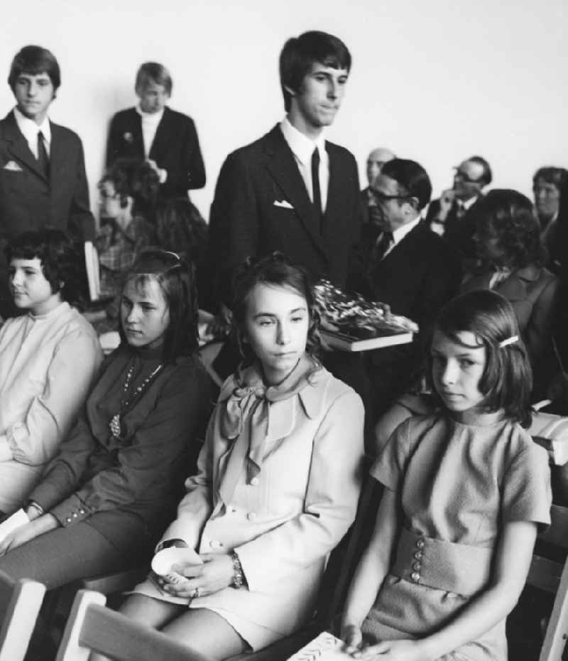 Youth Dedication Ceremony participants sitting on chairs and waiting in Berlin, the former capital of the GDR, the German Democratic Republic