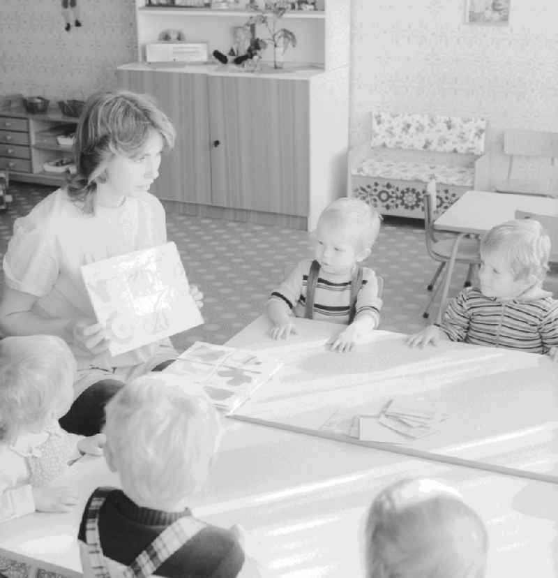 A teacher with children in a daycare center in Berlin, the former capital of the GDR, the German Democratic Republic