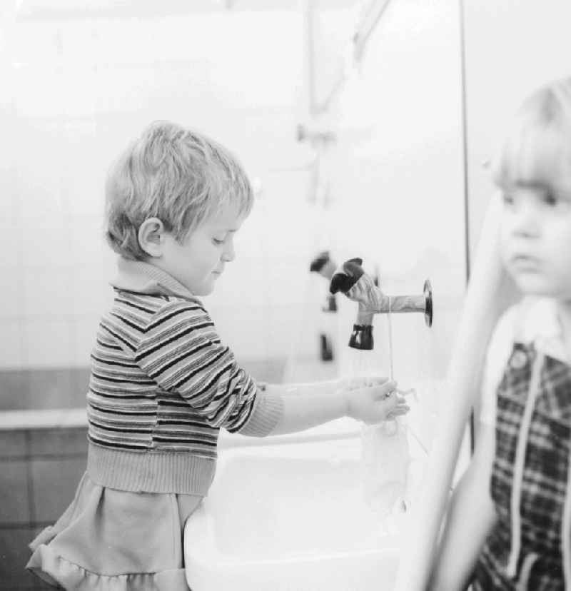 Child when washing your hands in a daycare center in Berlin, the former capital of the GDR, the German Democratic Republic