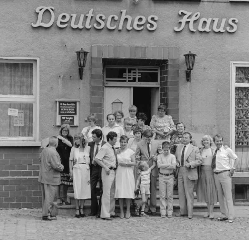 Family photo in front of the HO restaurant 'Deutsches Haus' in Berlin, the former capital of the GDR, the German Democratic Republic