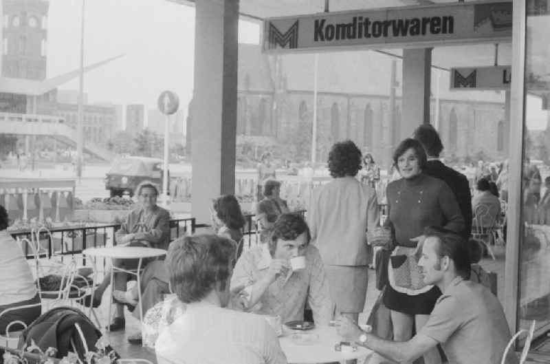 Tourists at a cafe at the Karl-Liebknecht-street in Berlin, the former capital of the GDR, the German Democratic Republic