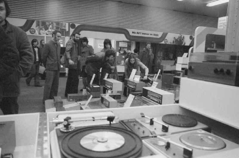 Customers in the broadcasting and radio department at the Centrum department store at Alexanderplatz in Berlin, the former capital of the GDR, the German Democratic Republic