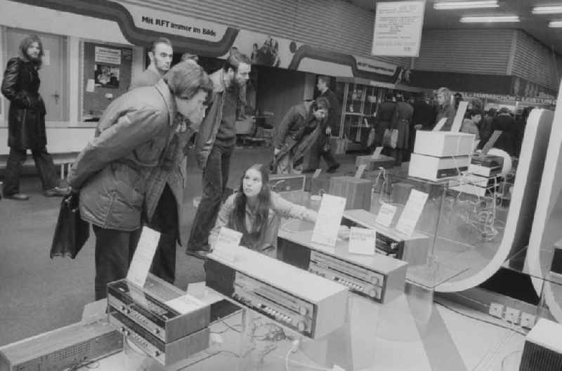Customers in the broadcasting and radio department at the Centrum department store at Alexanderplatz in Berlin, the former capital of the GDR, the German Democratic Republic