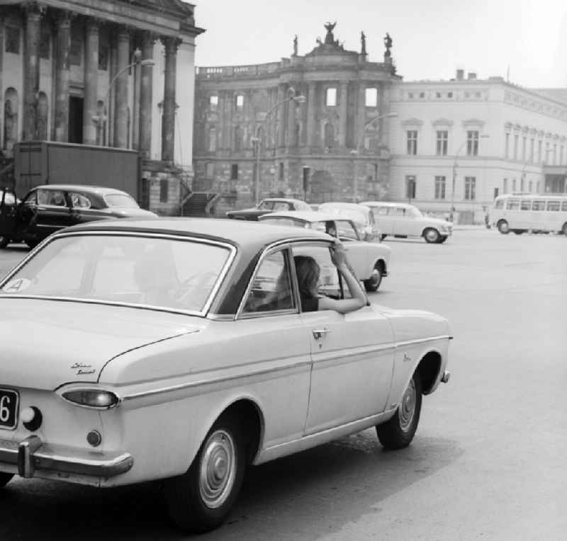 Tourists in Austria are in a Ford Taunus 12M Coupe traveling on the Unter den Linden boulevard in the center of Berlin, the former capital of the GDR, the German Democratic Republic