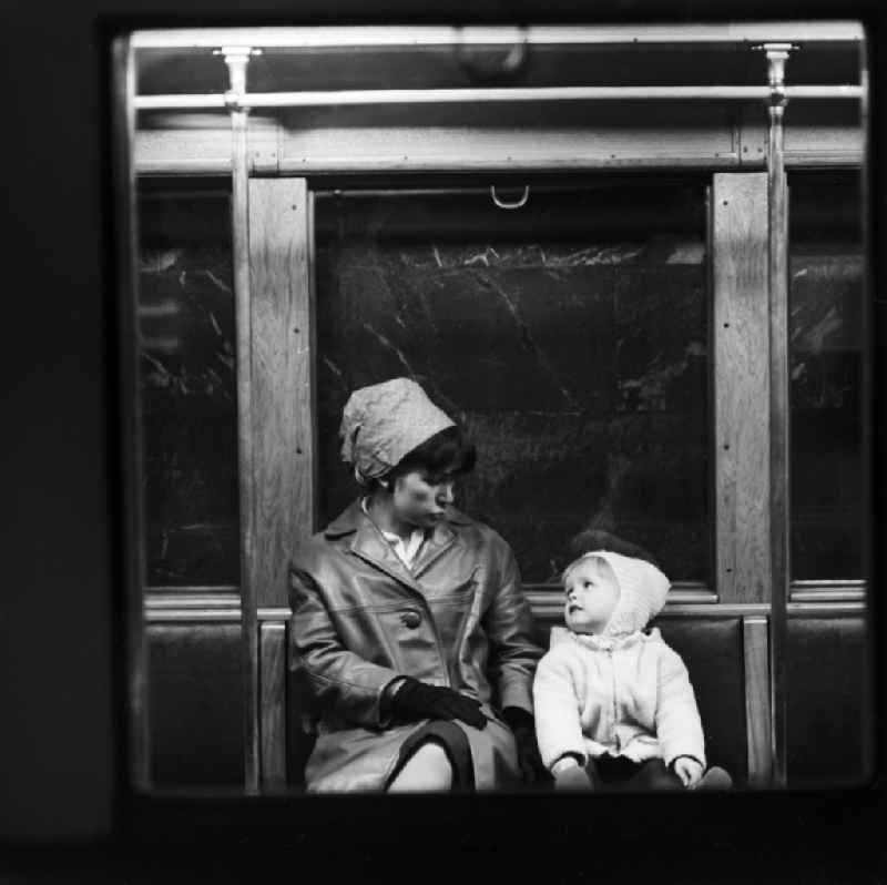 A mother sits with her child in the subway in Berlin, the former capital of the GDR, the German Democratic Republic