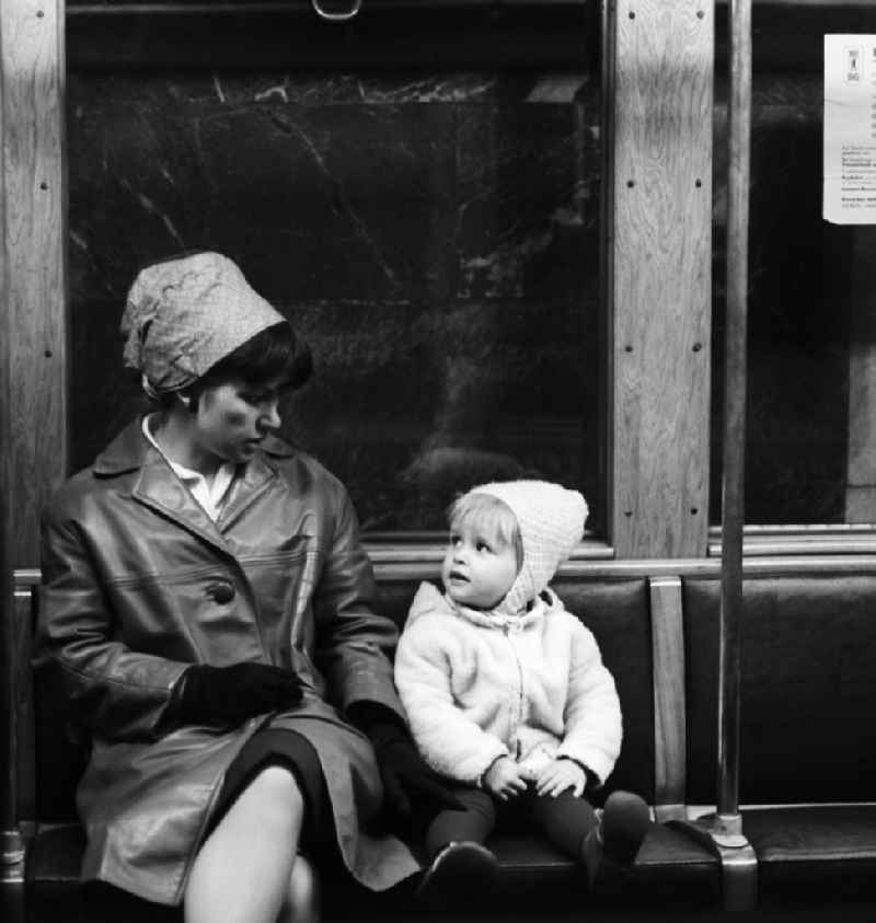 A mother sits with her child in the subway in Berlin, the former capital of the GDR, the German Democratic Republic