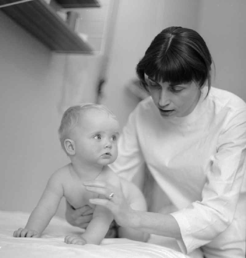 A doctor examines a toddler in the children's hospital in the Klinikum Berlin-Buch in Berlin, the former capital of the GDR, the German Democratic Republic
