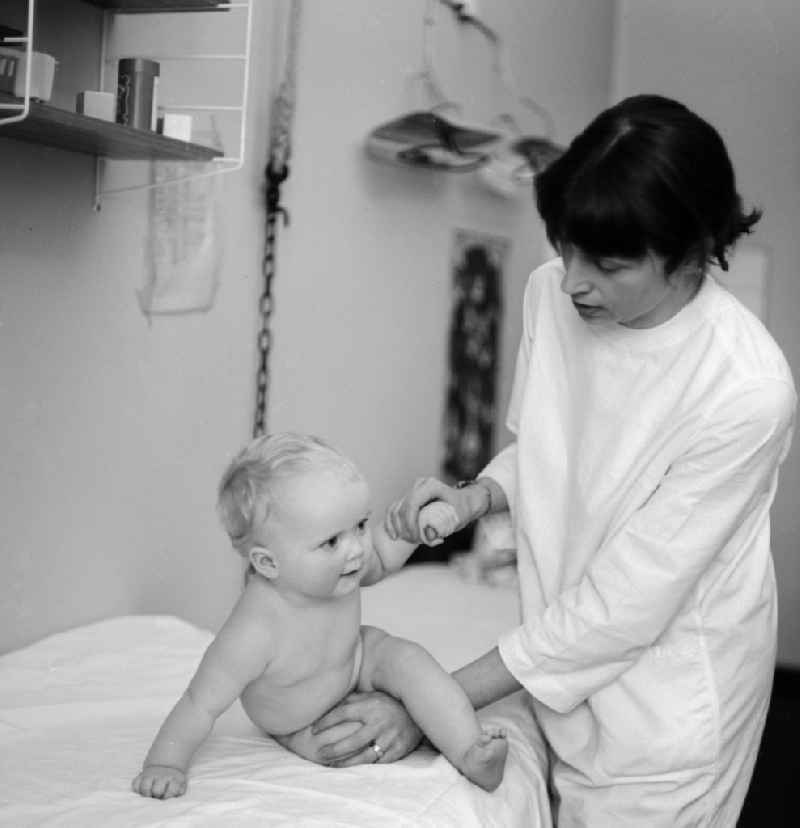 A doctor examines a toddler in the children's hospital in the Klinikum Berlin-Buch in Berlin, the former capital of the GDR, the German Democratic Republic