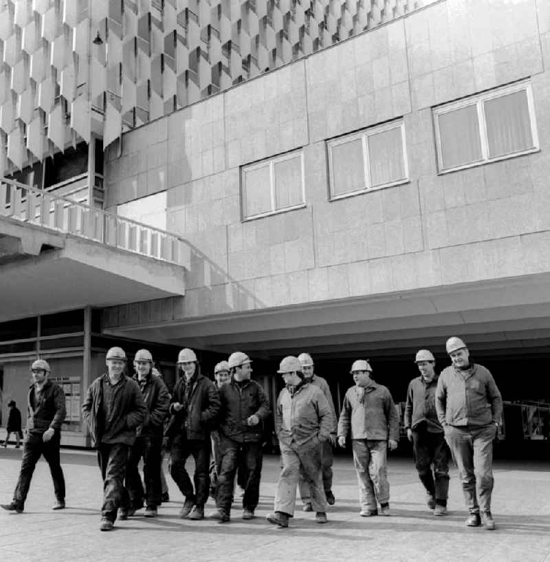 A group of construction workers in front of the Centrum department store in Berlin, the former capital of the GDR, the German Democratic Republic