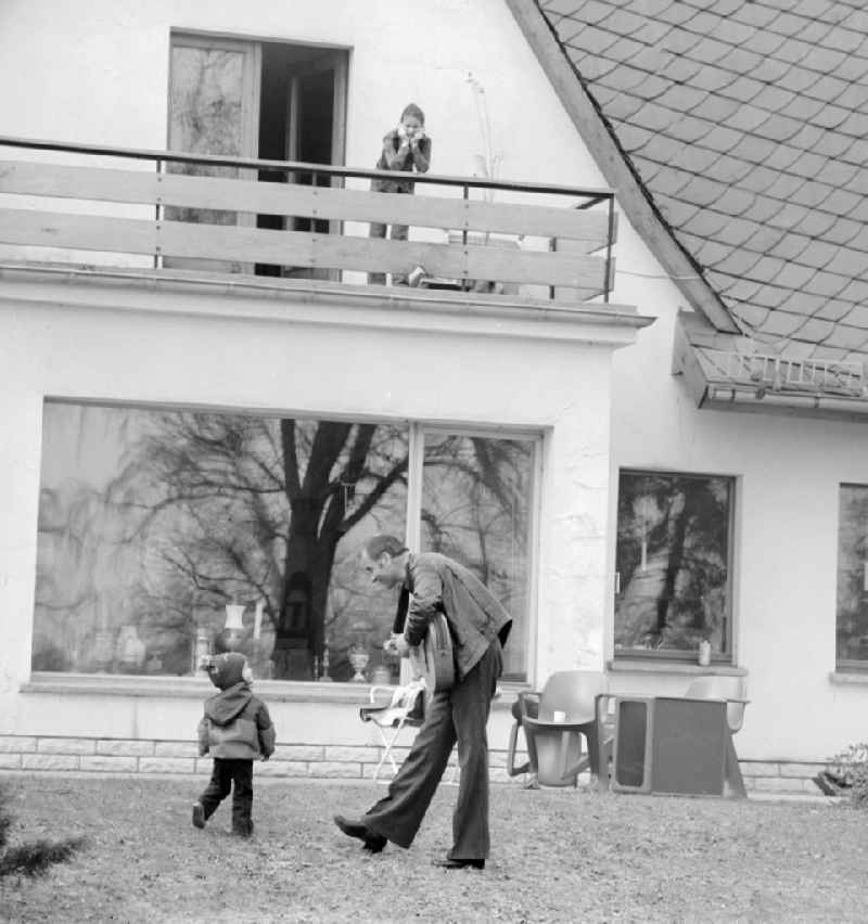 The actor, musician, painter and writer Armin Mueller-Stahl with his son Christian in the garden of his house in Berlin - Koepenick, the former capital of the GDR, the German Democratic Republic. AOn the balcony seteht his wife Gabriele