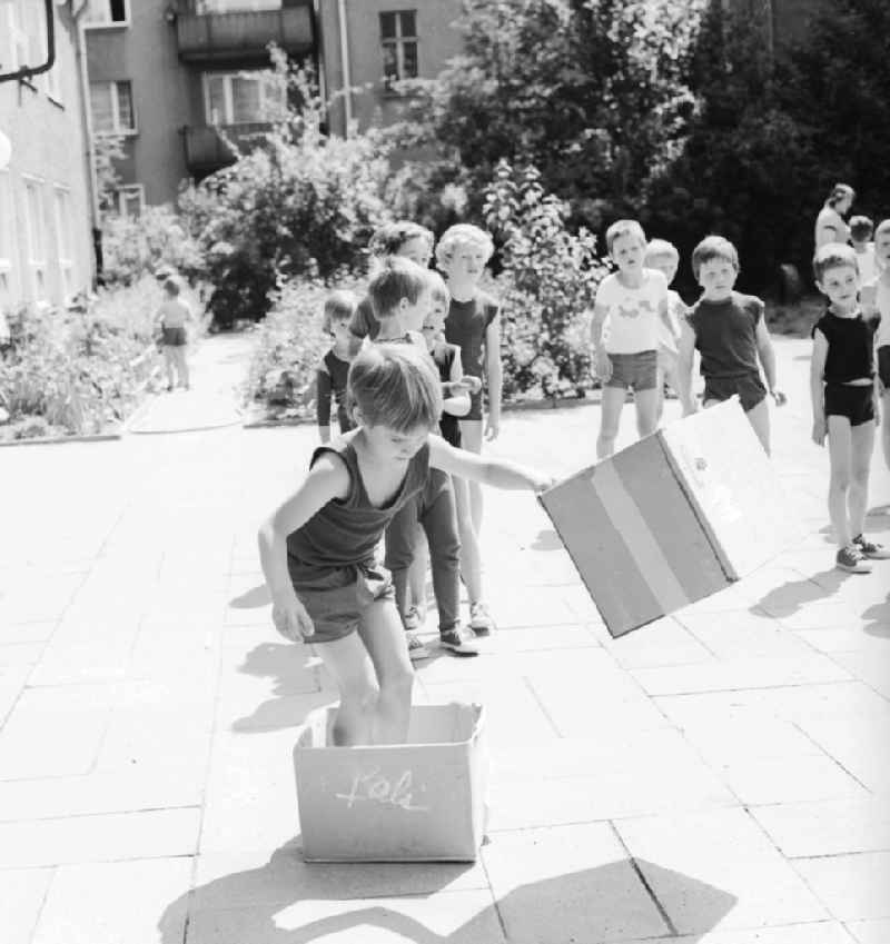 Children celebrate the International Children's Day at a preschool in Berlin, the former capital of the GDR, German Democratic Republic. On this day there was always a festive program which consisted of sport and play. Here at the box steeplechase