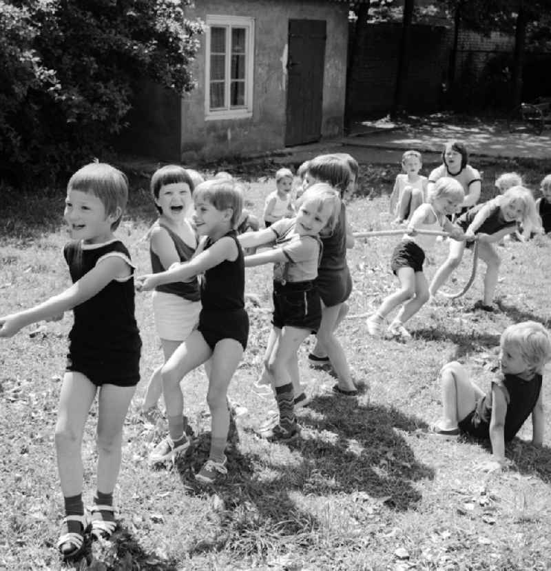 Children celebrate the International Children's Day at a preschool in Berlin, the former capital of the GDR, German Democratic Republic. On this day there was always a festive program which consisted of sport and play. Here the tug