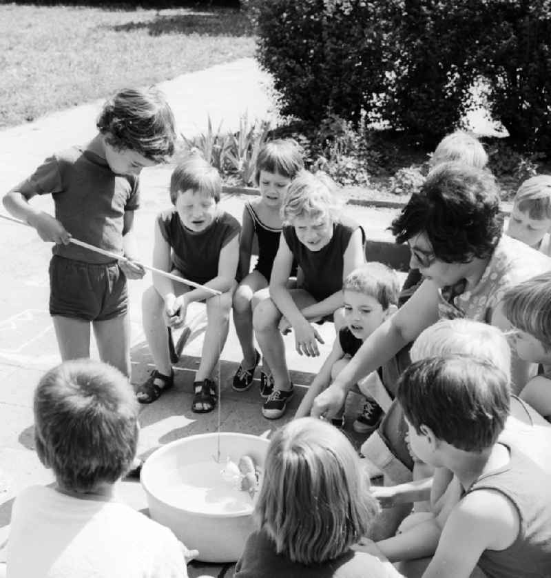 Children celebrate the International Children's Day at a preschool in Berlin, the former capital of the GDR, German Democratic Republic. On this day there was always a festive program which consisted of sport and play. Here in a fishing game