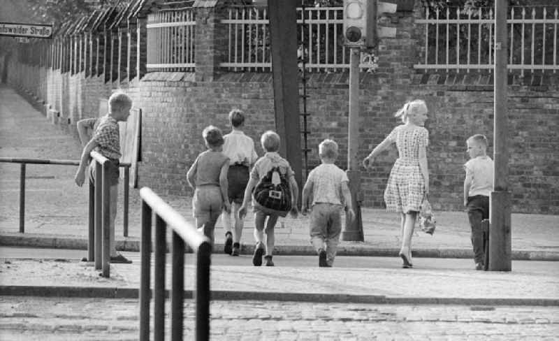 Children cross the Greifswalder street in Berlin, the former capital of the GDR, German Democratic Republic