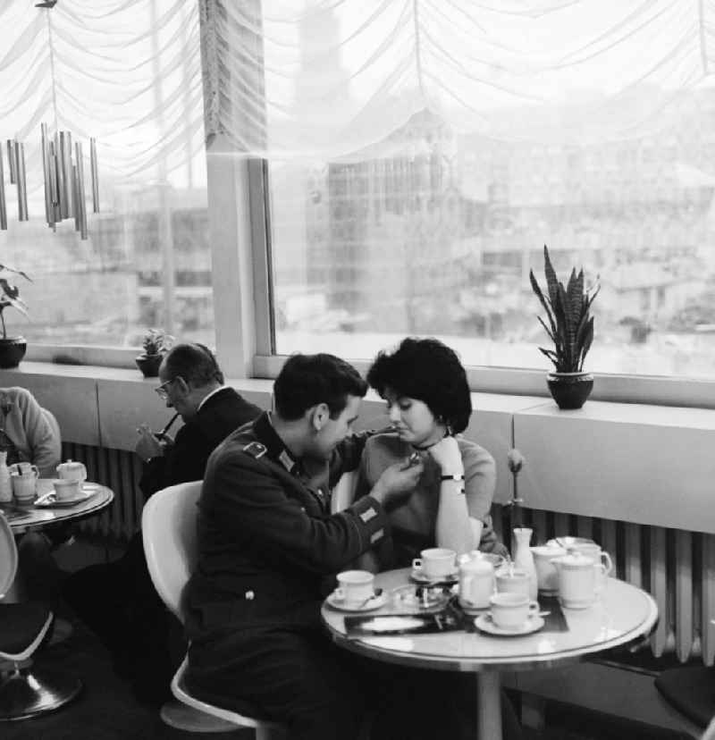 A soldier of the National People's Army (NVA) meets with his girlfriend in a cafe in Berlin, the former capital of the GDR, German Democratic Republic