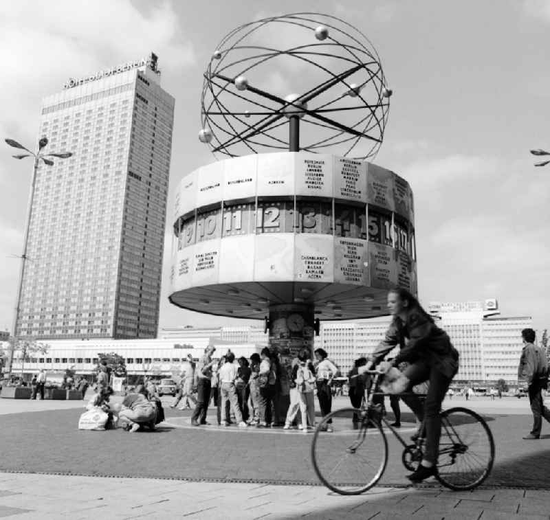 The Urania World Clock at Alexanderplatz in Berlin, the former capital of the GDR, German Democratic Republic. In the background the Hotel Stadt Berlin
