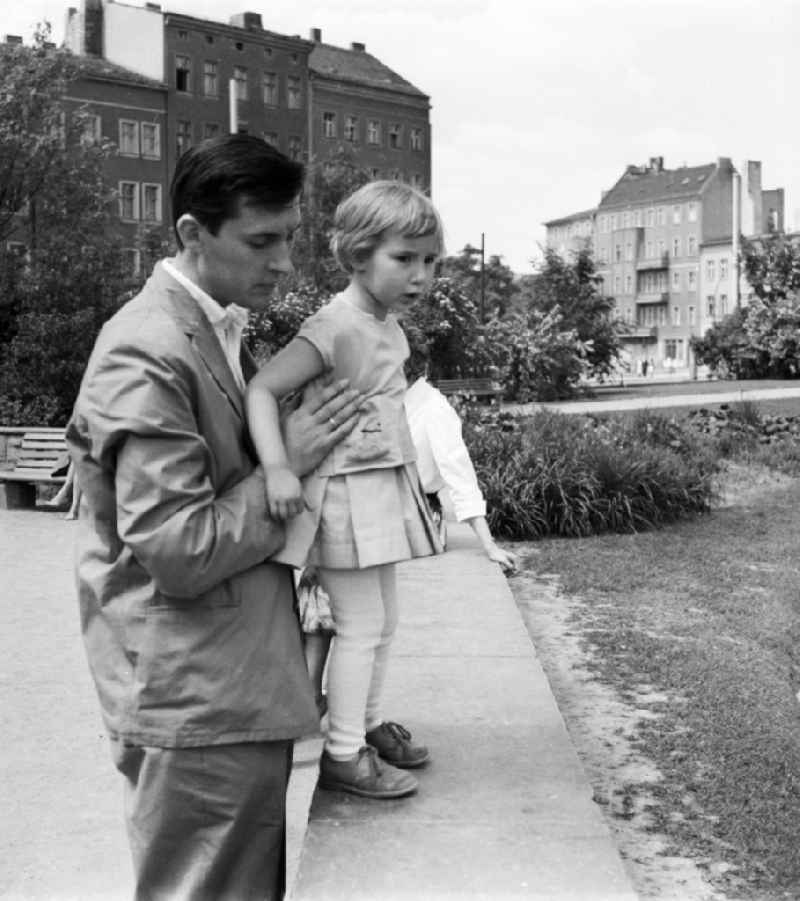 A young father with his small daughter in Berlin, the former capital of the GDR, German democratic republic