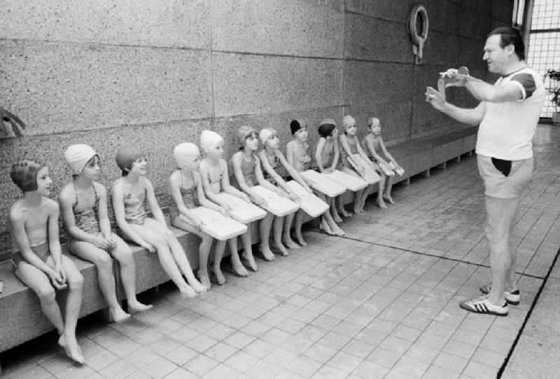 Swimming lessons of the class steps 2 and 3 in a swimming hall in Berlin, the former capital of the GDR, German democratic republic