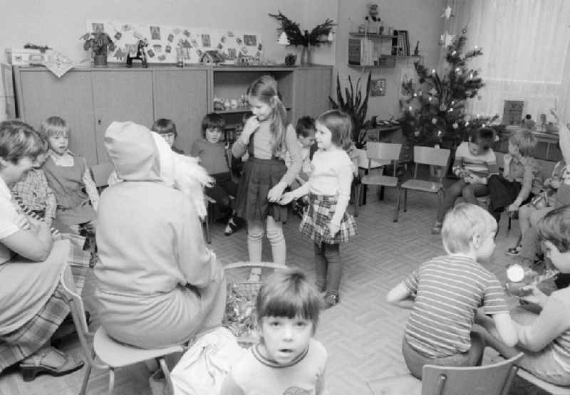 The Santa Claus gives children with presents in a kindergarten in Berlin, the former capital of the GDR, German democratic republic