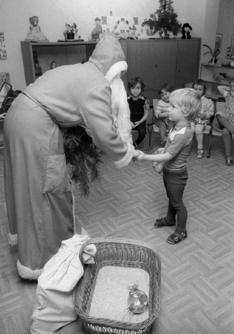The Santa Claus gives children with presents in a kindergarten in Berlin, the former capital of the GDR, German democratic republic
