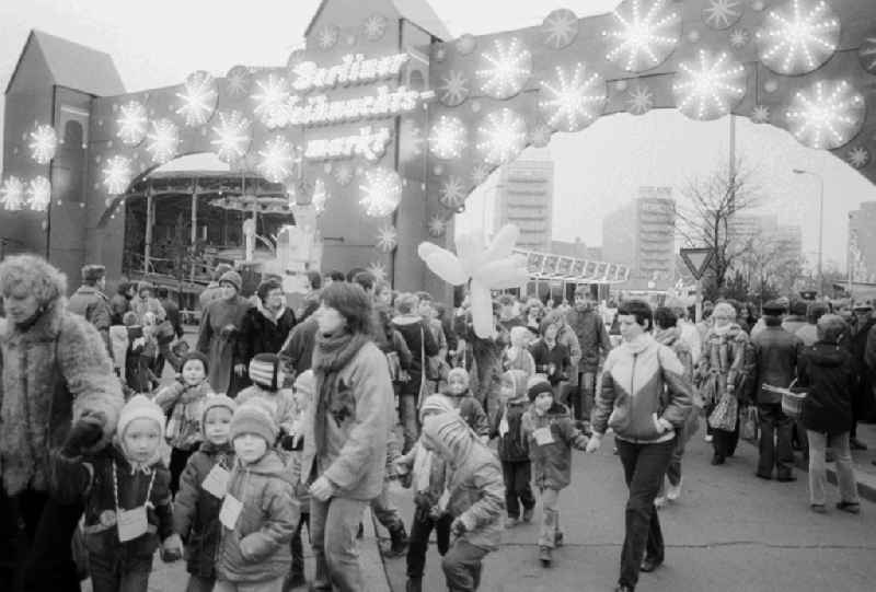 Visitors flow out by the main entrance on the Berlin Christmas fair in Berlin, the former capital of the GDR, German democratic republic. Today there stands at this point the shopping centre 'Alexa'