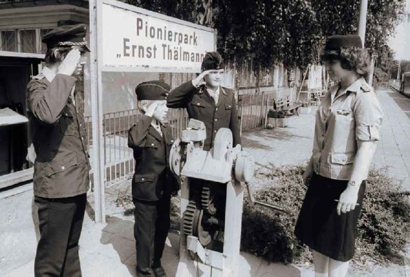 Children and youngsters in uniforms with the pioneer's railway in the pioneer's park / park road in the leisure centre and recreation centre (FEZ) in the Wuhlheide in Berlin, the former capital of the GDR, German democratic republic