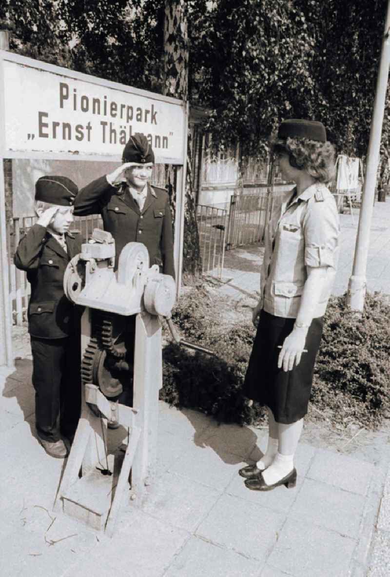 Children and youngsters in uniforms with the pioneer's railway in the pioneer's park / park road in the leisure centre and recreation centre (FEZ) in the Wuhlheide in Berlin, the former capital of the GDR, German democratic republic
