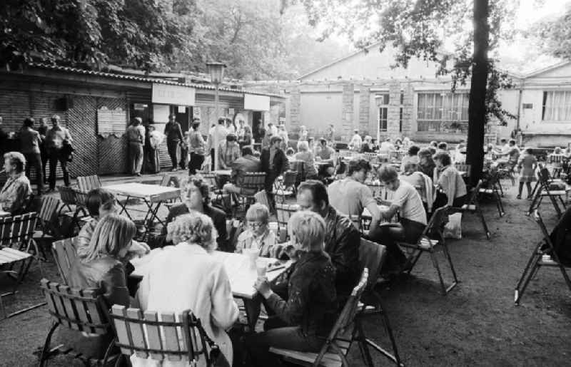 Guests and visitors in a holiday bar in the Treptower park in Berlin, the former capital of the GDR, German democratic republic