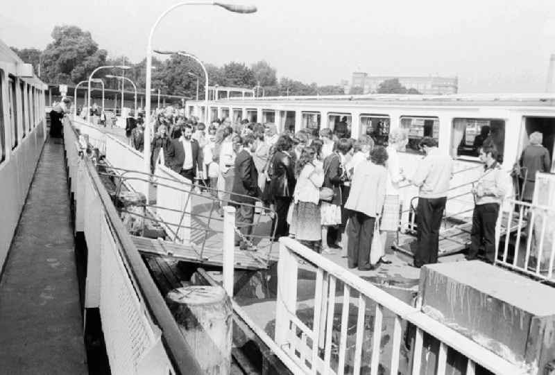 Guests and tourists in the steamboat landing stage of the 'white fleet' in the Treptower park in Berlin, the former capital of the GDR, German democratic republic