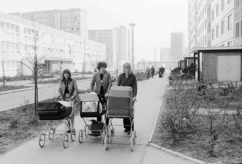 Three mothers by baby carriage in Berlin, the former capital of the GDR, German democratic republic