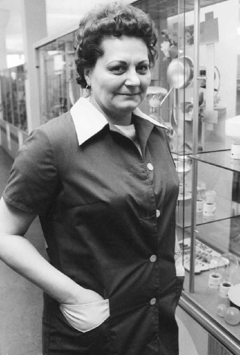 Portrait of a shop assistant with smock apron and perm in Berlin, the former capital of the GDR, German democratic republic