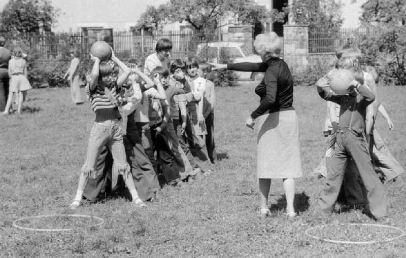 Schoolgirls and schoolboys in the holiday's plays / hoard on the summer holidays in Berlin, the former capital of the GDR, German democratic republic. The holiday's plays were  mainly for schoolboys first to the fourth class thought