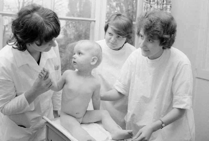 A girl is weighed by nurses of the clinic for paediatrics and youth medicine lime court in Berlin, the former capital of the GDR, German democratic republic. The children - hospital Lindenhof are a component of the Sana medical centres in the Berlin district bright mountain