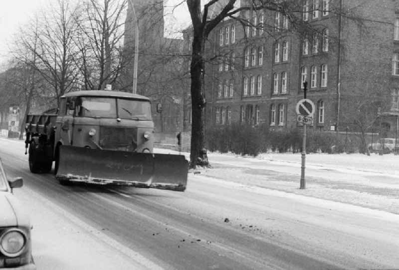A removing vehicle / snowy racketeer in use application on the streets in Berlin, the former capital of the GDR, German democratic republic