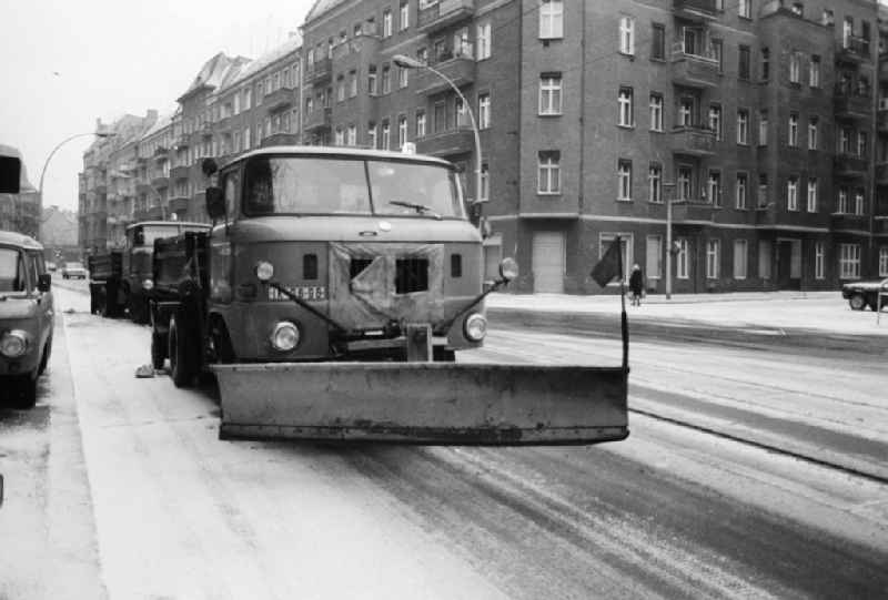 A removing vehicle / snowy racketeer in use application on the streets in Berlin, the former capital of the GDR, German democratic republic