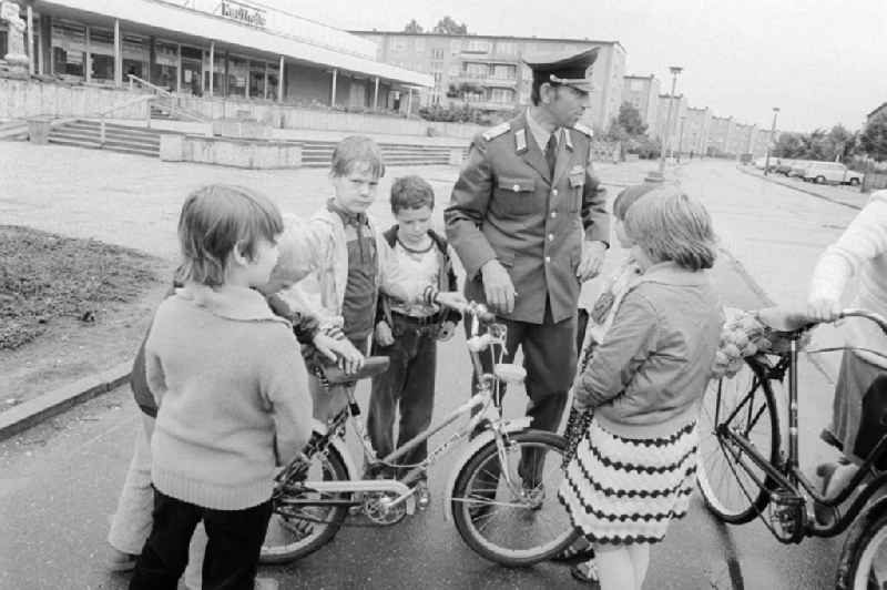 A member of the People's Police / of segment authorised representative (ABV) with the road safety education in Berlin, the former capital of the GDR, German democratic republic. Here he controls the traffic suitability of a bicycle of the children