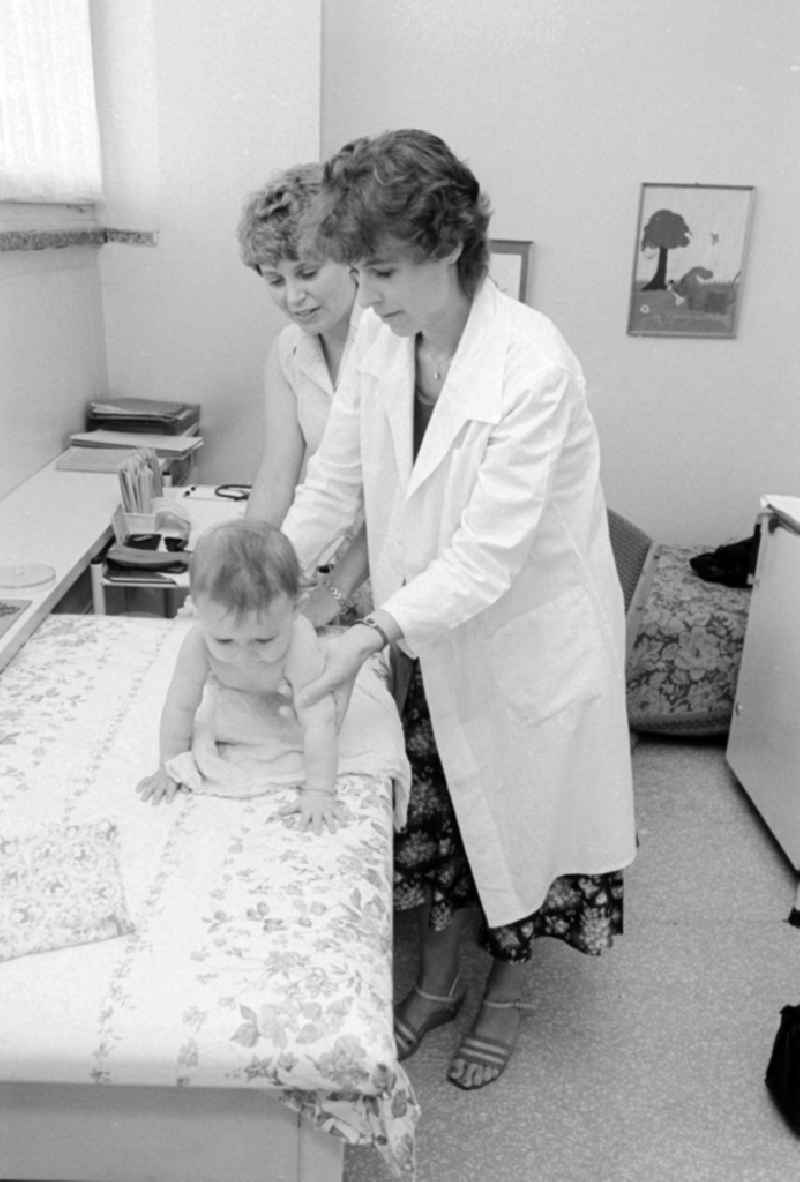 A doctor of the health service examines the physical development of children cooked to children in Berlin, the former capital of the GDR, German democratic republic