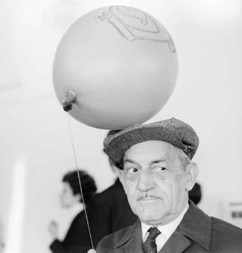 A grandpa with an balloon in Berlin, the former capital of the GDR, German democratic republic