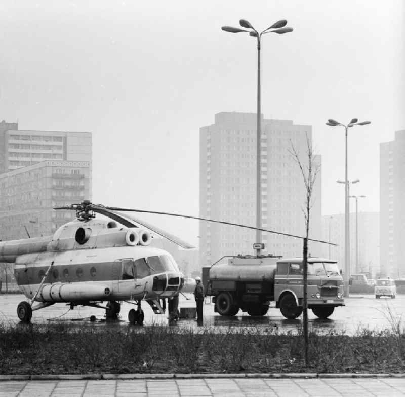 A transport, load helicopter Mil Mi-8 of the INTERFLUG, with the call sign DM-SPB is refuelled on a parking bay, in Berlin, the former capital of the GDR, German democratic republic