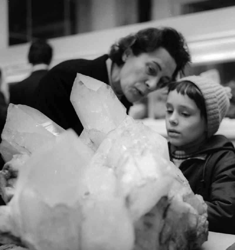 A grandmother and her grandson marvel at a large crystal mineral stone in the Natural History Museum in Berlin, the former capital of the GDR, German Democratic Republic