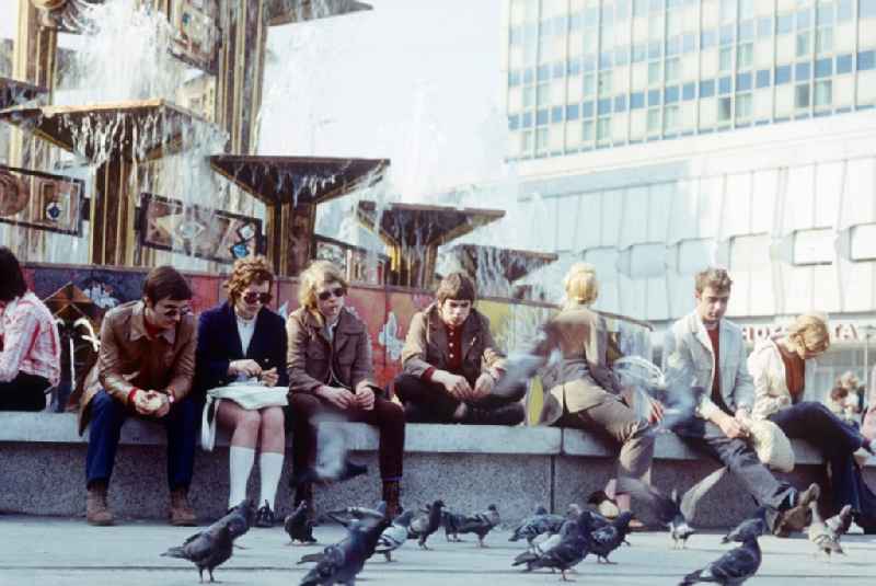 Tourists in front of the Fountain of International Friendship in Alexanderplatz in Berlin, the former capital of the GDR, German Democratic Republic. The fountain designed Walter Womacka under the redesign of Alexanderplatz