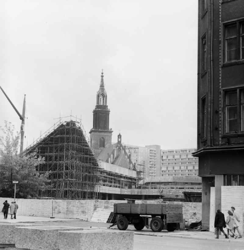 Construction site for the new Berlin television tower in Berlin, the former capital of the GDR, German Democratic Republic. In the background the Marienkirche on Karl-Liebknecht-Strasse