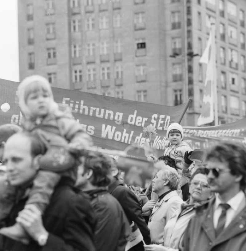Enthusiastic GDR citizens with children and family at the May 1 demonstration in Berlin, the former capital of the GDR, German Democratic Republic