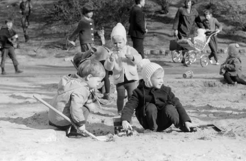 Children playing in the sandpit in Berlin, the former capital of the GDR, German Democratic Republic