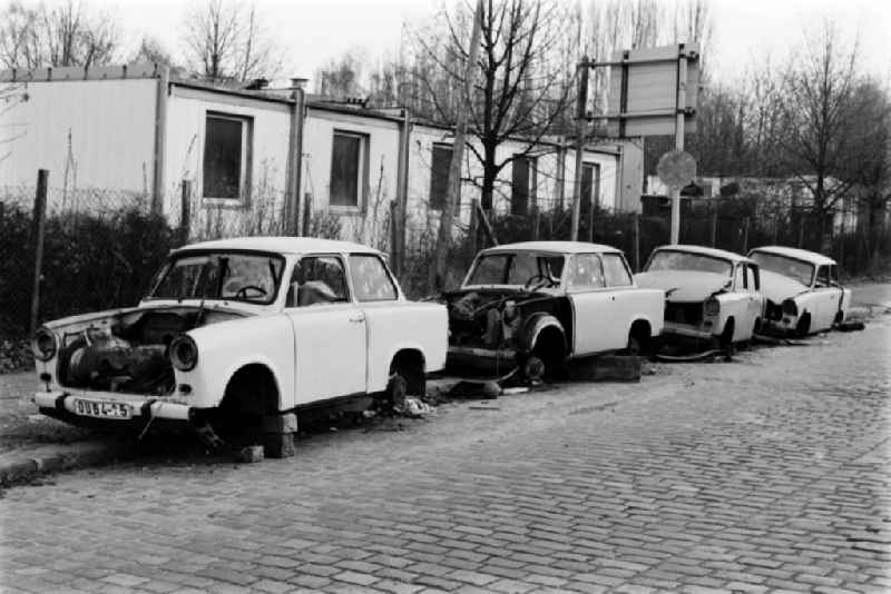 Destroyed car wrecks of the type Trabant are standing on a roadside in Berlin - Friedrichshain, the former capital of the GDR, German Democratic Republic