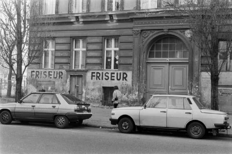 Street scene in front of a dilapidated old building facade with the words 'Barber' in Berlin - Prenzlauer Berg, the former capital of the GDR, German Democratic Republic